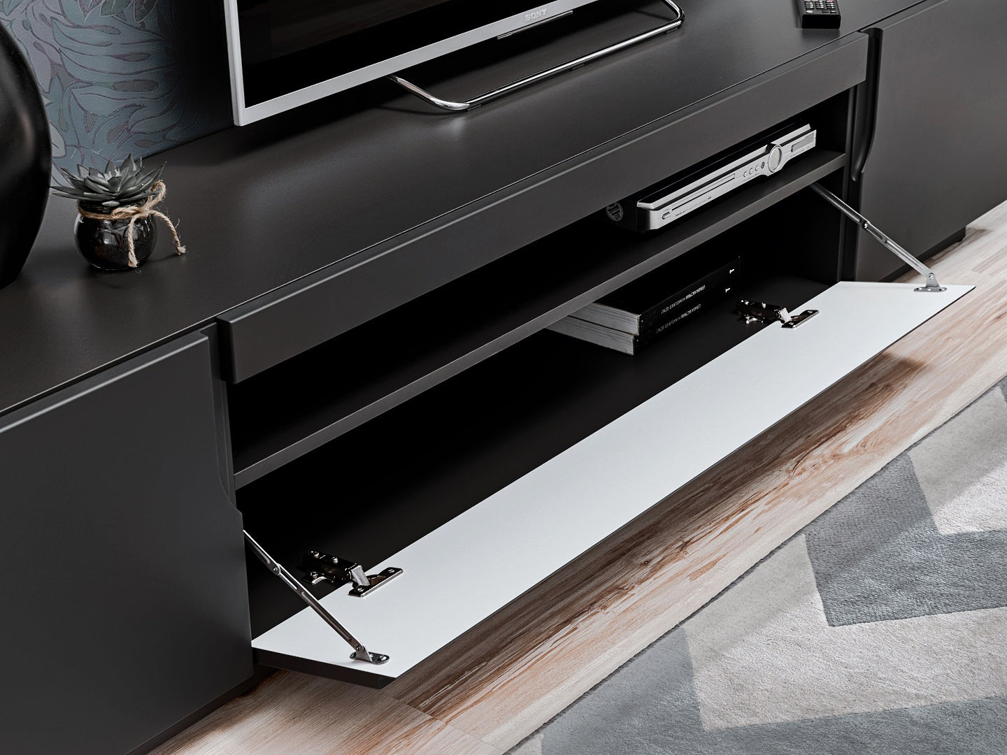 Crafted with high-quality materials, this modern TV stand features ample storage space for your media essentials. The open shelving provides easy access to your media devices, while the discreet storage compartments keep clutter at bay. The unit is designed to accommodate various sizes of flat-screen TVs, making it a versatile and practical addition to any living room or entertainment area.